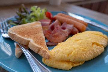 breakfast, scrambled egg with toppings, sausage, bread, bacon