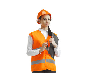 Destroying gender stereotypes. Female builder in orange helmet standing on white studio background....