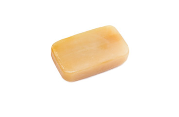 Removing stains with bile( gall, sap) soap bar. Natural chemical free household clothing washing products concept. Brown soap bar isolated on white.