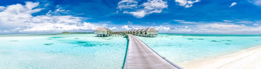 Fototapeten Panoramic landscape of Maldives beach. Tropical panorama, luxury water villa resort with wooden pier or jetty. Luxury travel destination background for summer holiday and vacation concept. © icemanphotos