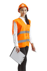 Destroying gender stereotypes. Female builder in orange helmet standing on white studio background....