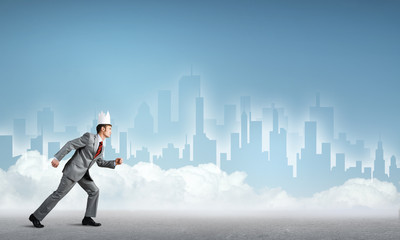 Fototapeta premium King businessman in elegant suit running and blue cityscape silhouette at background