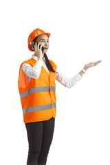 Destroying gender stereotypes. Female builder in orange helmet standing with phone on white studio background. Safety specialist, engineer, occupation, businesswoman, job concept. Woman in the male