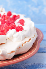 pavlova cake with raspberries and whipped cream