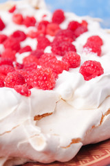 pavlova cake with raspberries and whipped cream