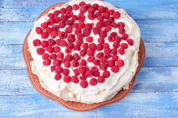 pavlova cake with raspberries and whipped cream