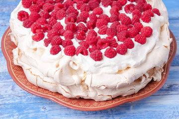 pavlova cake with raspberries and whipped cream