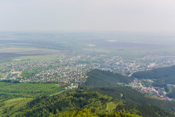 Fototapeta premium Panoramic view of the city from above and mountains