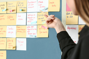 Young woman near scrum task board in office