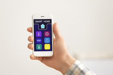 Teenage boy using application of smart home automation