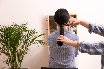 Woman cutting hair of young girl. Concept of donation