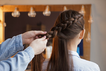 Naklejka premium Hairdresser working with client in beauty salon