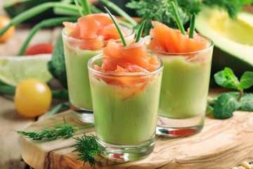 Appetizer with salted salmon and avocado cream with green onion, selective focus