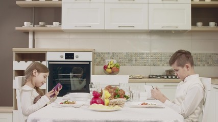 Children Speak At The Table Before A Family Dinner