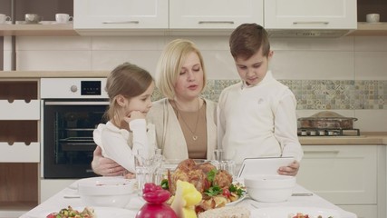 Mom Communicates With Her Children At The Table During A Family Dinner