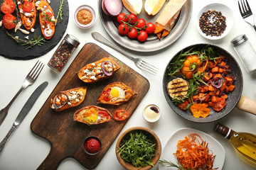 Assortment of tasty dishes with sweet potato on white background