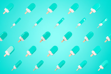 Pattern made of flying glossy  green lolly ice cream on the blue background.