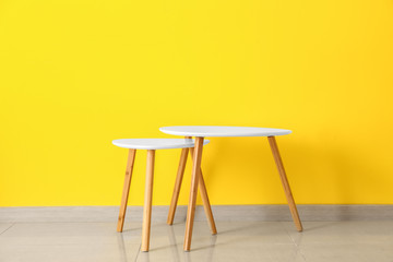 Table and stool near color wall