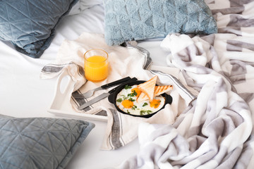 Tasty healthy breakfast on bed