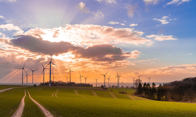 Obraz na płótnie Canvas Sunset with wind turbines
