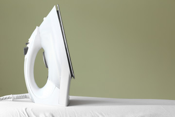 Modern iron on board against white background