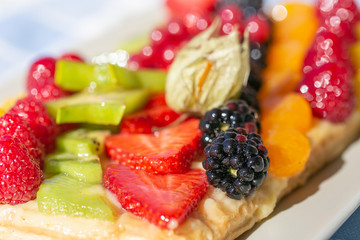 close-up view of a tart with stripes of fruits aligned