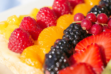 close-up view of a tart with stripes of fruits aligned