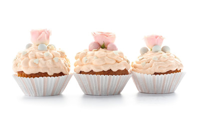 Tasty Easter cupcakes on white background