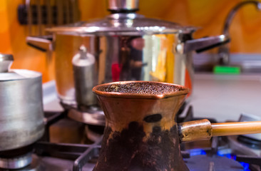 part of kitchen interior - shelves with glass doors, gas stove, dishes, close up