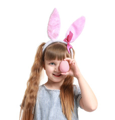 Cute little girl with Easter egg and bunny ears on white background