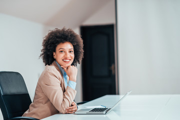 Young business woman in office working at the desk.