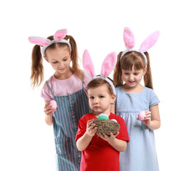Cute little children with Easter eggs and bunny ears on white background