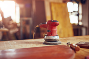 Orbital electric sander in a retro vintage workshop.