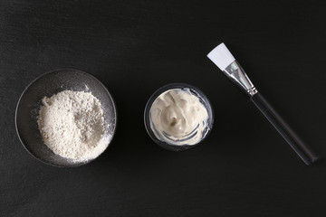 Cosmetic clay with brush on dark background