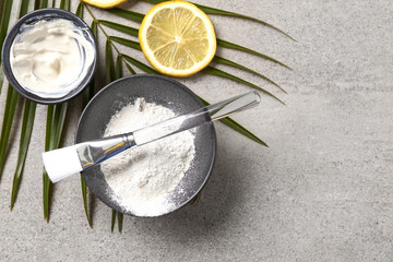 Cosmetic clay with brush on grey table