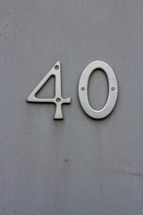 House number forty with the 40 in silver metal screwed onto the door