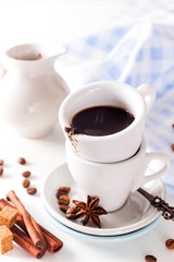 Coffee cup with coffee beans and brown sugar on white stone background. Copyspace for your text