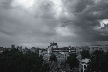 Storm clouds in the sky over the city. Gray gloomy sky before hurricane