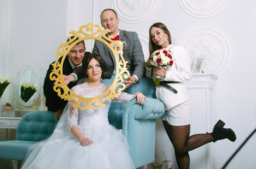 wedding photoshoot in the Studio. the bride and groom with friends having fun