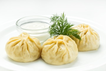 Geogrian dumpling khinkali with meat and vegetables, close up on a white background