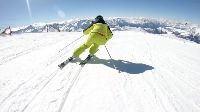Female skier go down on ski route