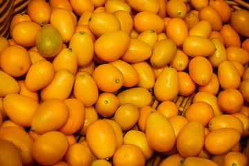 Top view of bunch of fresh kumquats in the organic food market.