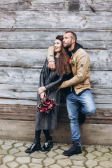 Tender romantic cheerful happy couple walking outdoors hugging and kissing each other outdoors in park. Relationships, love, hipster couple concept