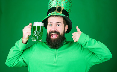 May the luck of the Irish be with you. Hipster leprechaun holding beer mug. Irish man showing...