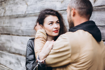 Tender romantic cheerful happy couple walking outdoors hugging and kissing each other outdoors in park. Relationships, love, hipster couple concept