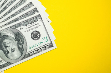 100 dollars on a yellow background