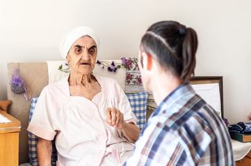 Very old senior woman having a conversation with her grandson