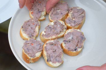 Sandwiches with pate on a white plate close-up