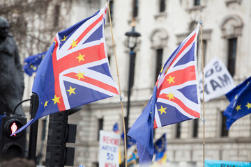 Fototapeta na wymiar European Union and British flags fly together at an anti-Brexit political march