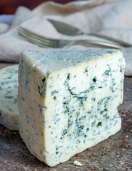 Fourme Ambert and Blue Auvergne semi-hard AOP French blue cheeses made from raw cow milk in Auvergne, France